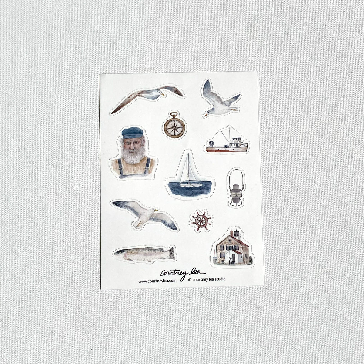Set of nautical-themed stickers on a white card with a light gray background