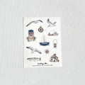 Set of nautical-themed stickers on a white card with a light gray background