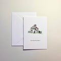Greeting card with a lighthouse watercolor illustration and envelope on a light background